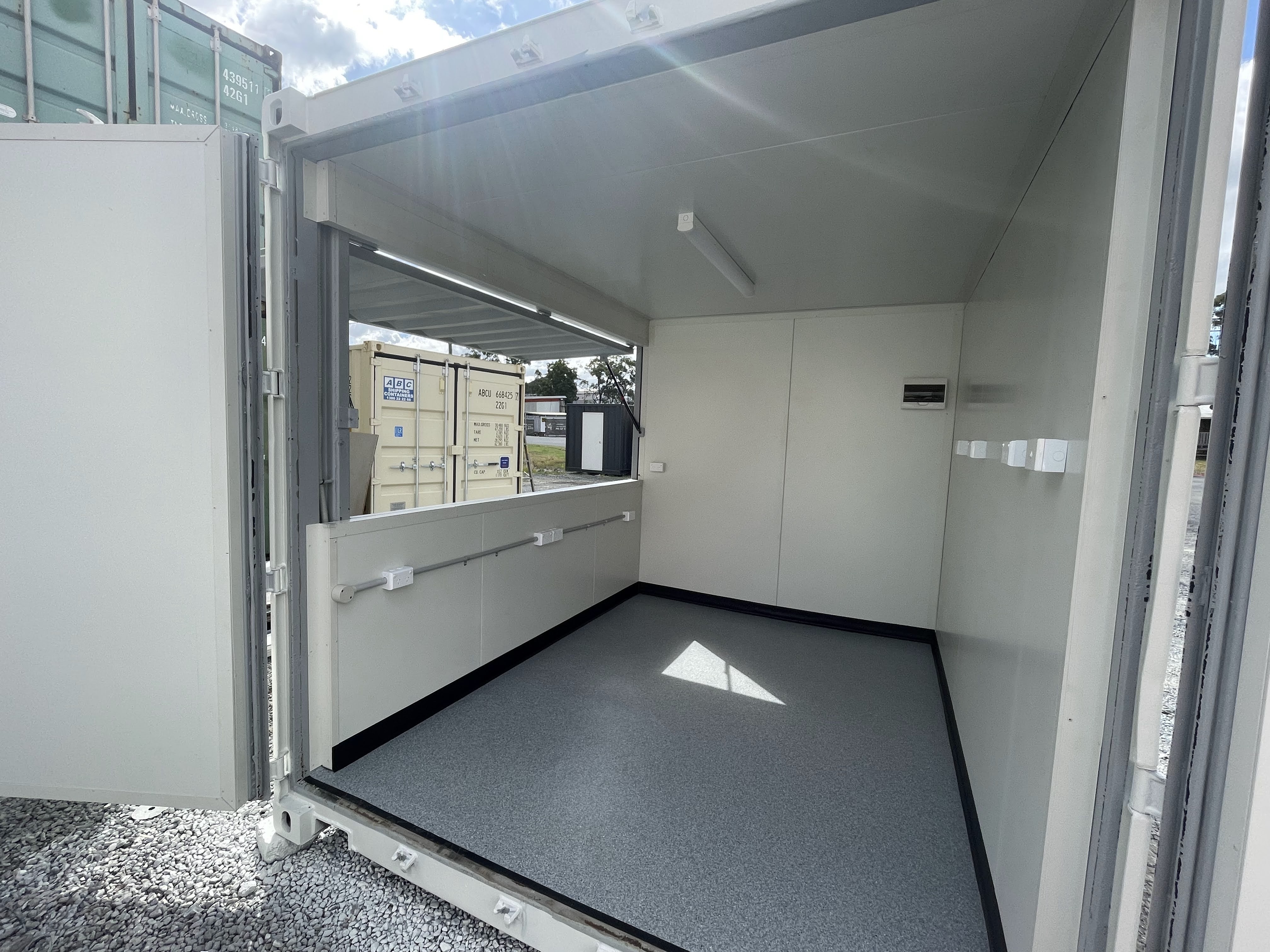 Modified shipping container with a servery window